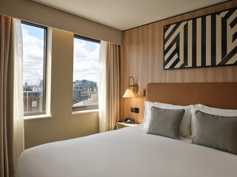 Bed and window view at at Imperial London Hotels